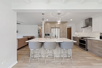Kitchen with beige island  and beige flooring 