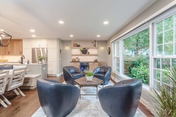 Living room with beverage center and four chairs around a hexagon table 