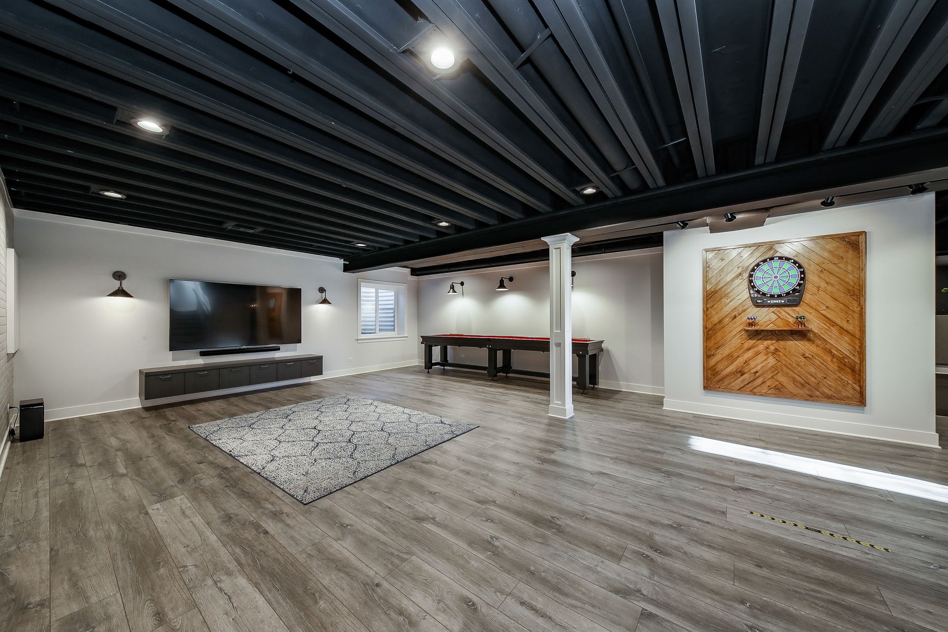Dartboard in Basement with wood slats. 