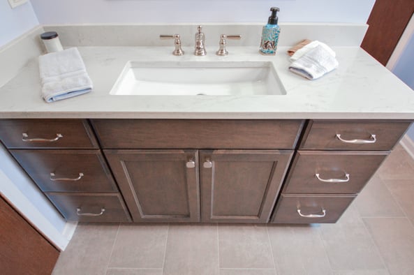 Bathroom vanity with brown cabinets 