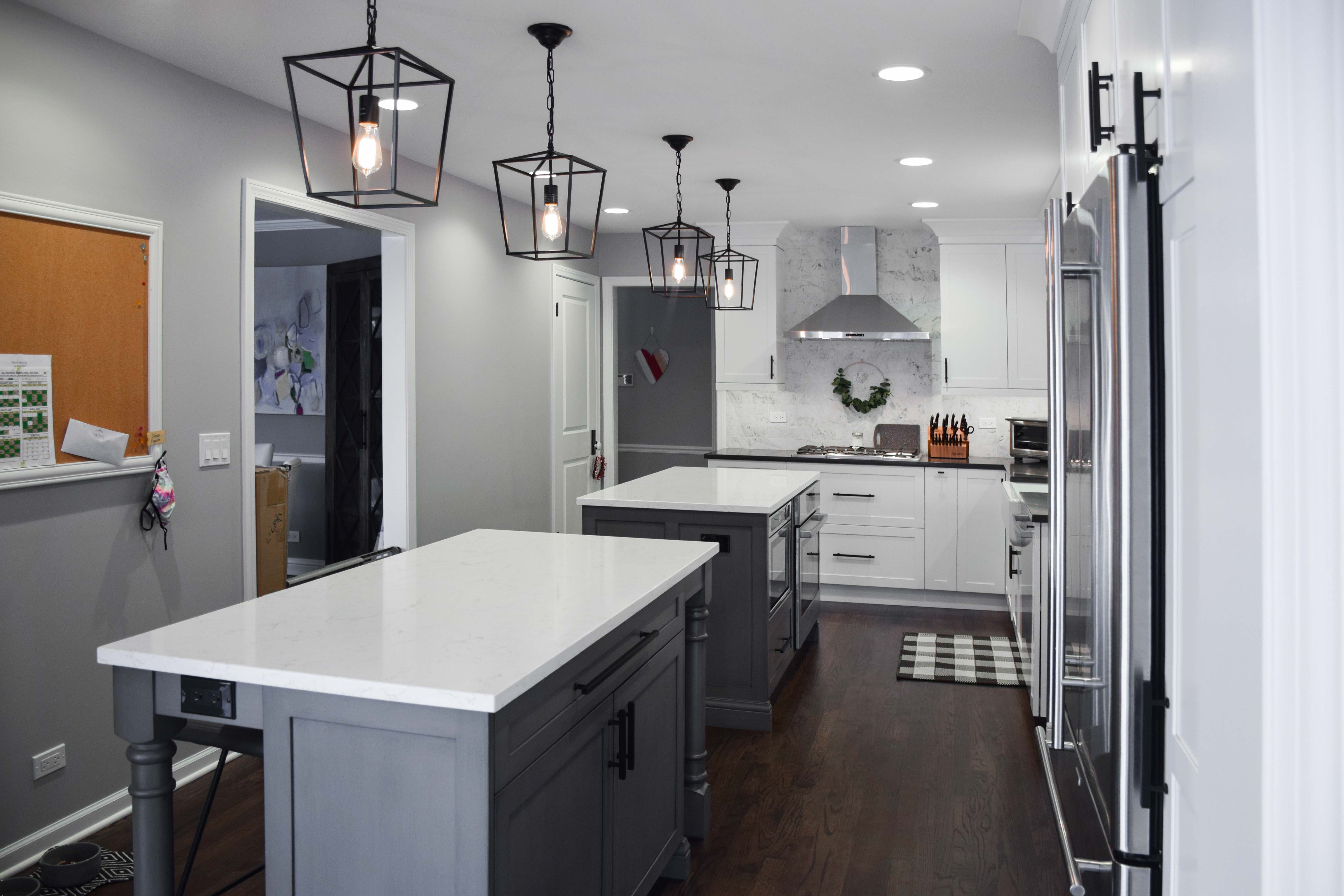 Gray kitchen with double islands and white countertops 