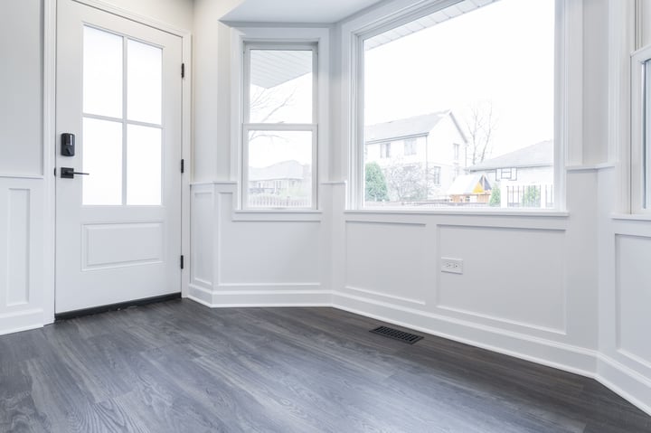 dark grey wood floors and white Wainscot paneled walls 