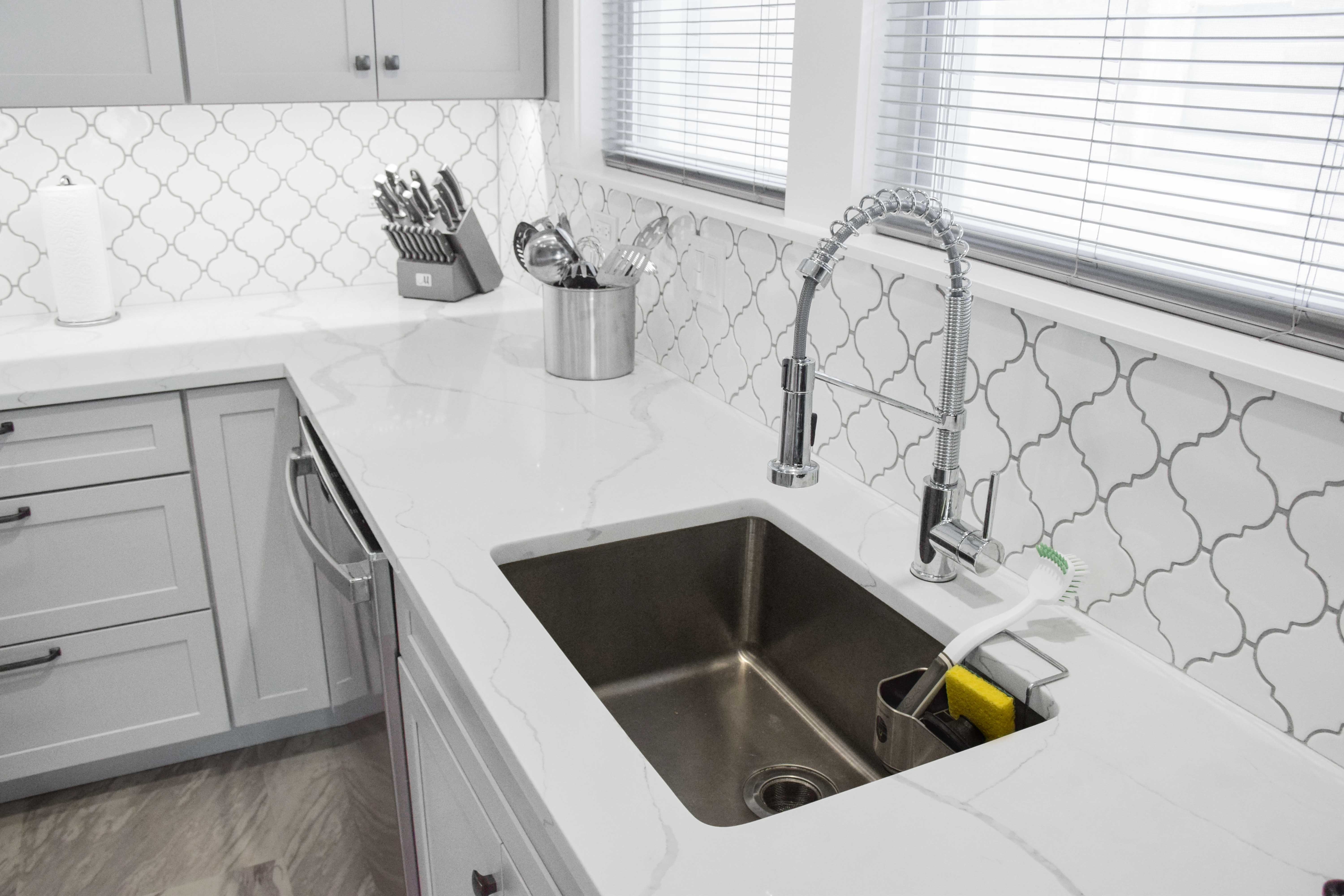 White and grey kitchen with silver faucet 