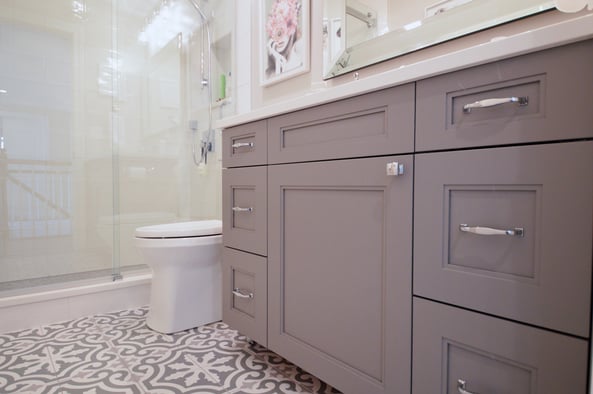Bathroom with grey cabinets and chrome hardware 