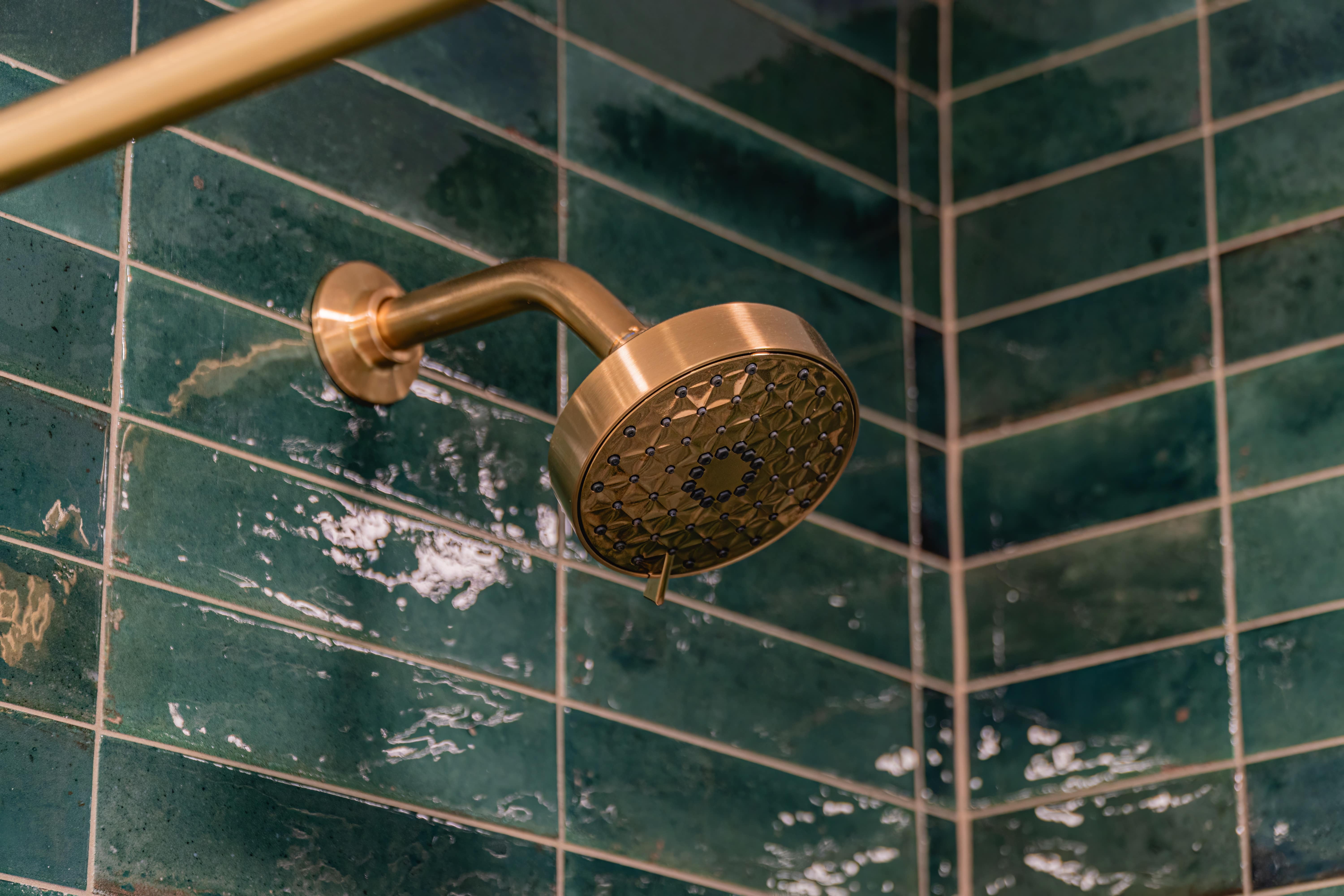 Shower with gold lux faucet and herbal wall emerable green tiles 