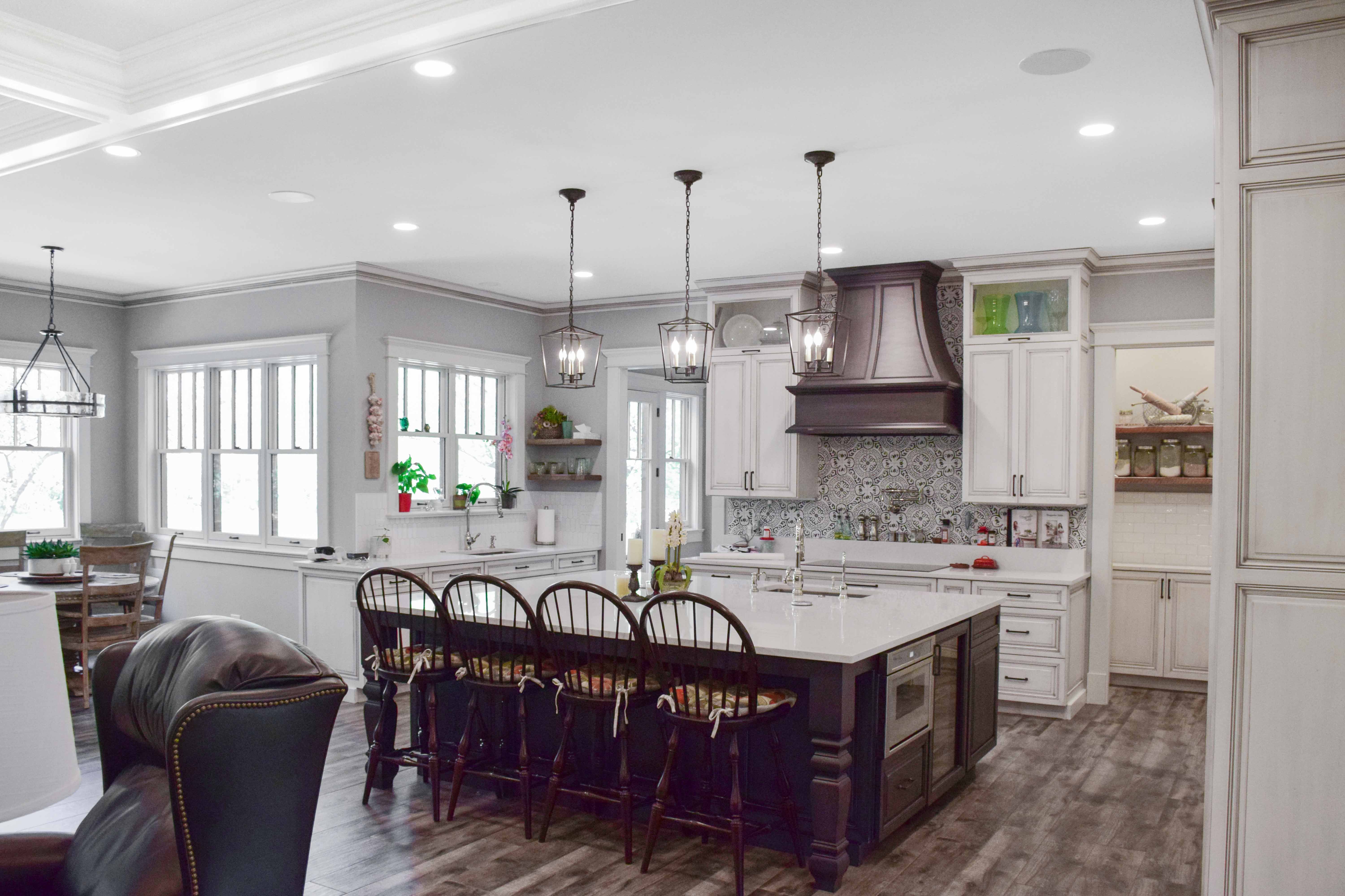 brown and white kitchen with large four seater island built in drink cooler and sink