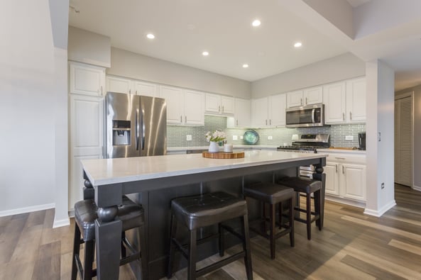 Large grey and white island with carved table legs 