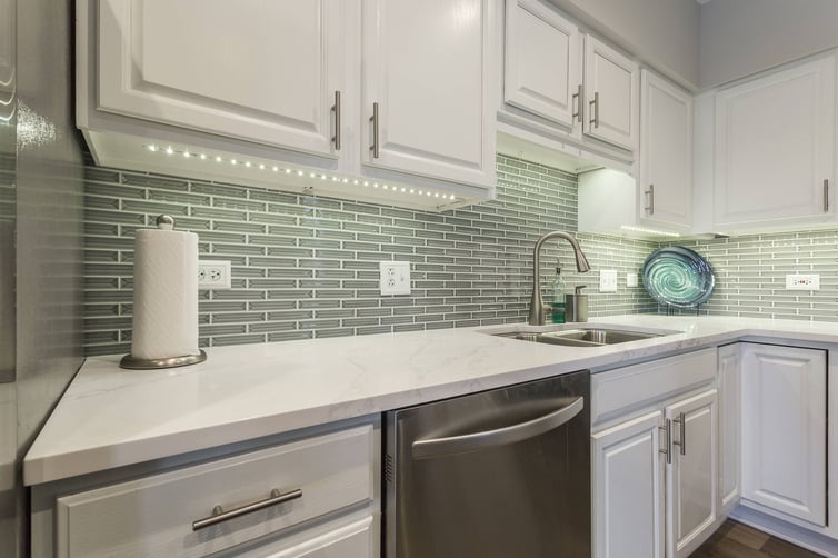 Refreshed kitchen with quartz countertops and white cabinets 