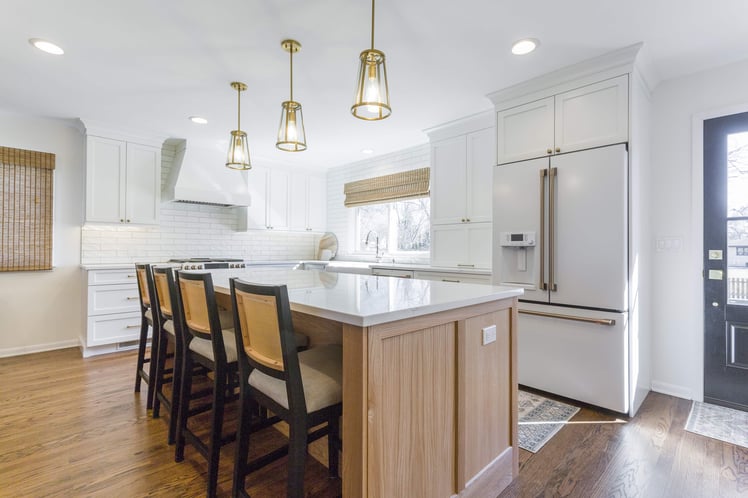 Tan and white kitchen with wood four seater island 
