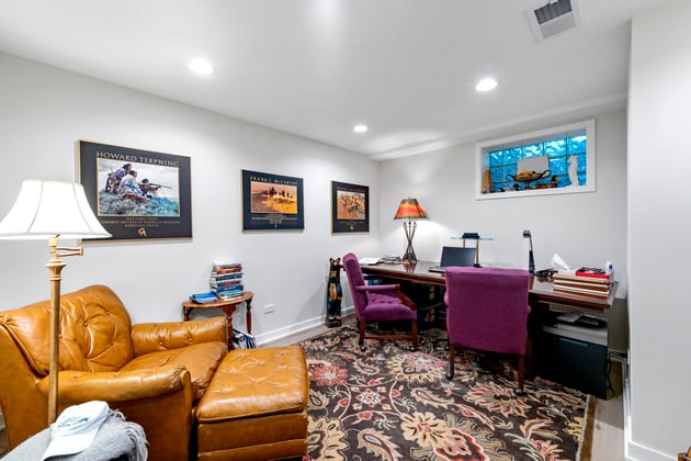 basement with patterned rug and purple chair 