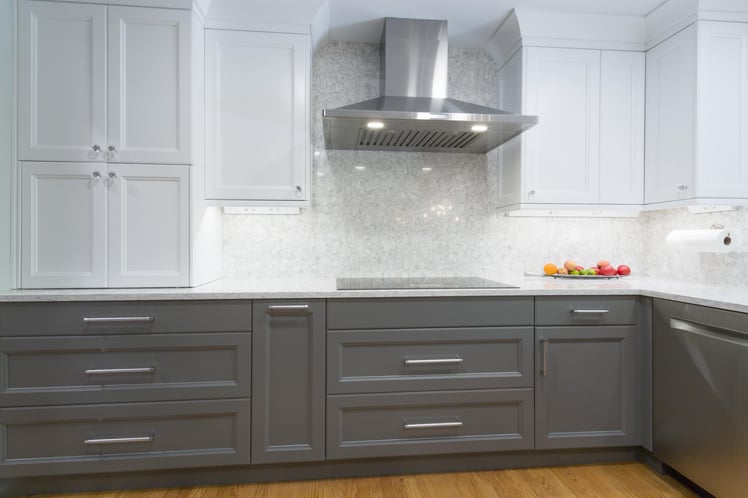 Kitchen with grey and white cabinets silver hardware 