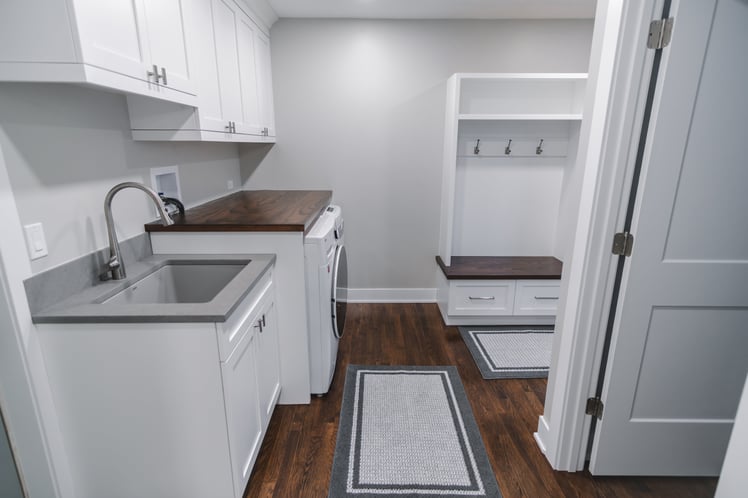 White and brown laundry room with drop-off zone built in 